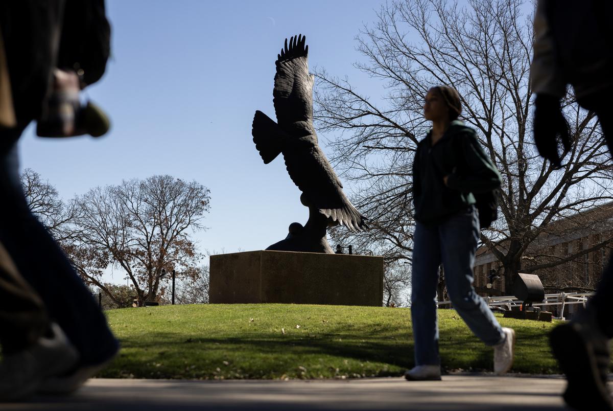 University of North Texas students walk past the eagle statue on Feb. 13, 2024. The Soaring Eagle Statue was comissioned in celebration of UNT's centennial in 1990.