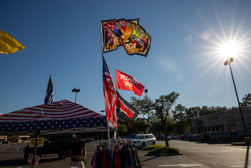 Flags wave on Election Day at a merchandise stand in Kingwood owned by resident Homer Price.