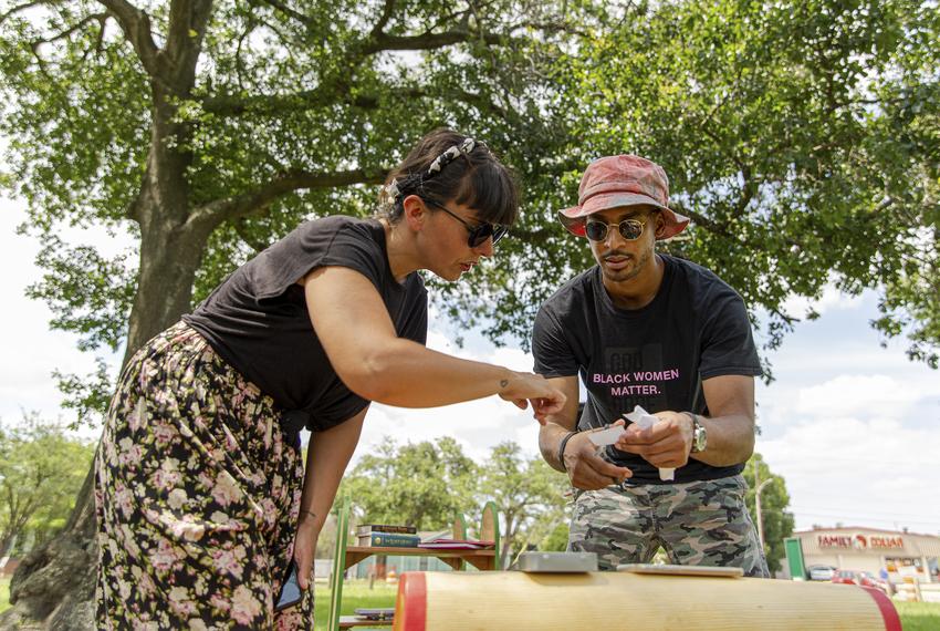 Helena Acosta and Josef Pierre engage in an activity as part of Violette Bule's public art installation 'Rethinking Your Neighborhood: A Collaborative Experience' in Houston, Texas on June 12, 2021.

Helena identifies as Latina and uses feminine pronouns. Josef identifies as Black and uses masculine pronouns.