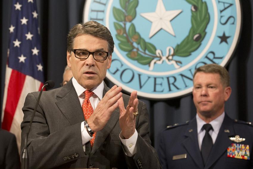 Gov. Rick Perry announces the deployment of National Guard troops along the Texas border as Texas Guard Adjutant General John Nichols listens at the Texas Capitol on July 21, 2014.