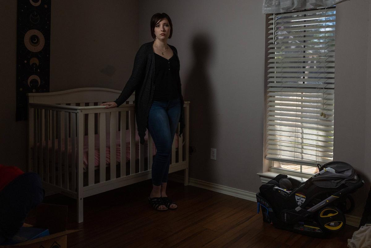 Lauren Hall stands for a portrait in the room that would have been her child’s in her home on September 10, 2022. Hall had a non-viable pregnancy and had to leave the state in order to terminate, revealing gaps in the state's miscarriage exception after Roe v. Wade was overturned.