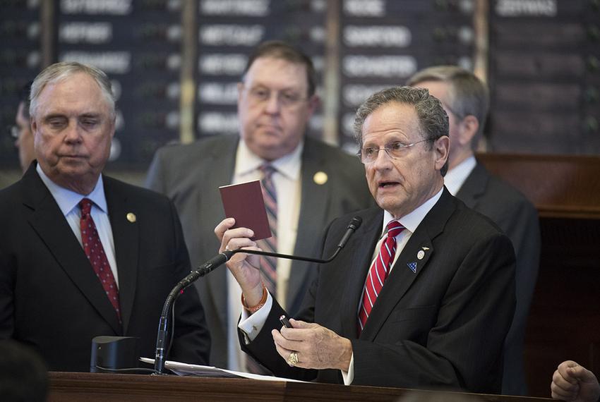 State Rep. Rick Miller, R-Sugar Land, holds a copy of the U.S. Constitution while on the floor of the Texas House on May 4, 2017.