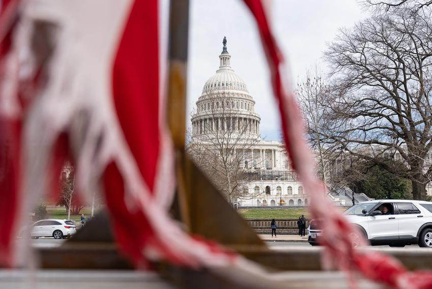 The U.S. Capitol is seen from a tattered U.S. flag on a truck part of the People’s Convoy in Washington, D.C. on March 10, 2022.