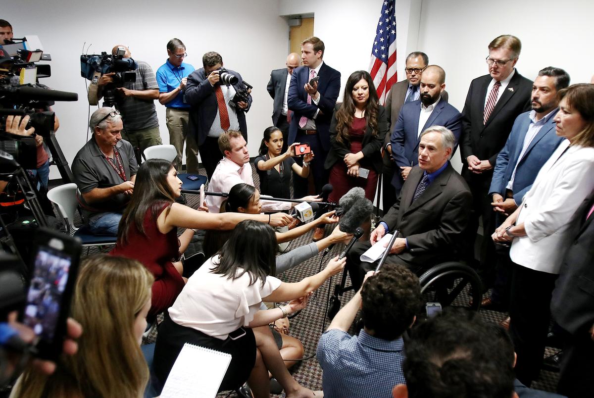 Flanked by El Paso lawmakers, Gov. Greg Abbott talks to the press after meeting with state legislators on Wednesday, August 7, 2019. From left (in front of flag): State Rep. Mary González, D-Clint; state Sen. José Rodríguez, D-El Paso; state Rep. Joe Moody, D-El Paso; Lt. Gov. Dan Patrick; and El Paso state Reps. Cesar Blanco and Lina Ortega. Also present, not pictured: State Rep Art Fierro and House Speaker Dennis Bonnen.