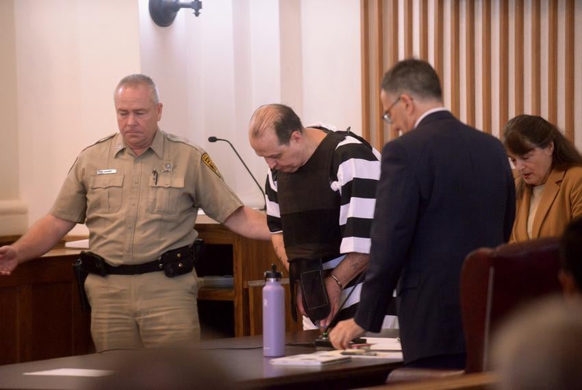 Shackled and chained, Robert Roberson is led away from his lawyers by an Anderson Co. Sheriff’s Office deputy Wednesday morning after a new execution date of Oct. 16, 2025 was set by presiding Judge Austin Jackson of Smith County at the Anderson County Courthouse in Palestine.