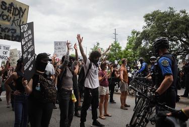 Arms raised, protesters face off with police in downtown Austin on May 31, 2020.