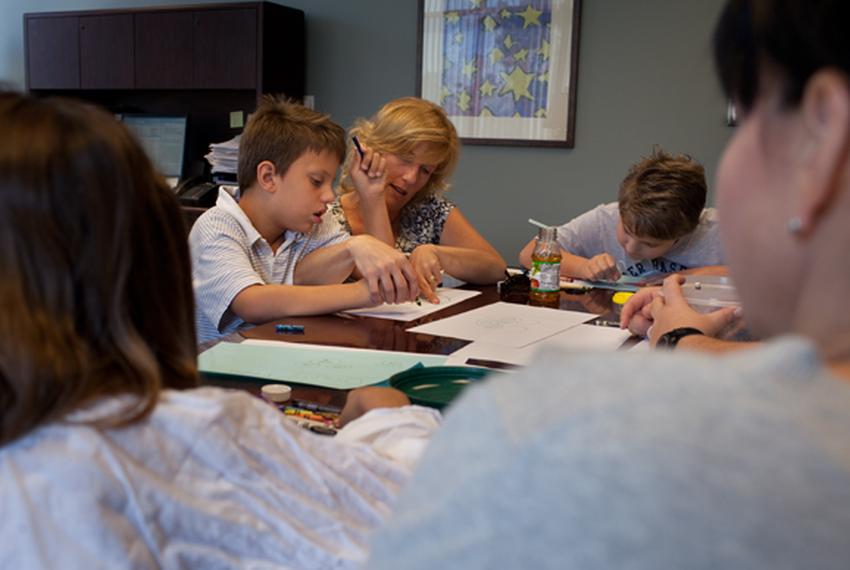 Karen Godfrey and her two sons Timothy Godfrey, and Zachary Munn draw and play together with Ishele Graves and her daughter Mikaela Massey at Bluebonnet Trails Community Services in Round Rock, TX.