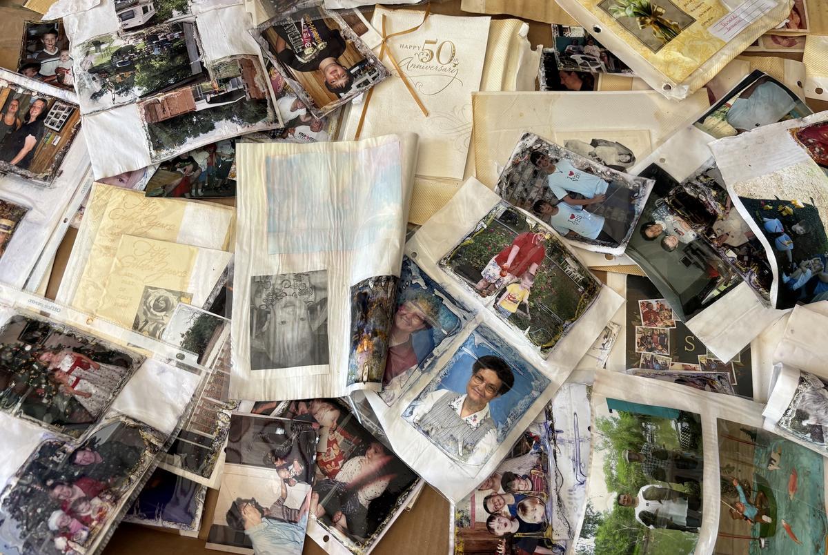 The Hefner family’s water-damaged photographs and mementoes dry out in a shed.
