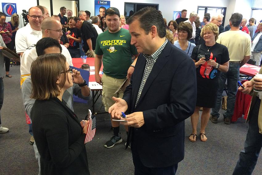 Presidential contender and U.S. Sen. Ted Cruz speaks with a supporter at the opening of his first Iowa office in Urbandale, Iowa on Sept. 26, 2015.