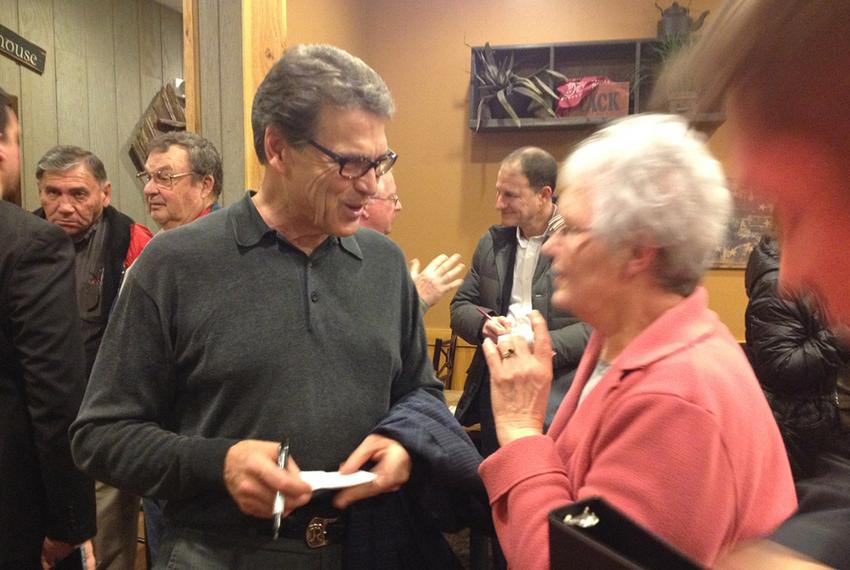 Former Texas Governor Rick Perry campaigns at a Pizza Ranch in Indianola, Iowa.