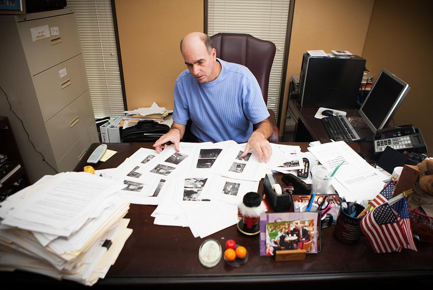 Victim Advocate for the City of Houston Andy Kahan, with crime scene photos printed off websites showing dead bodies, many unclothed, in his office at the Houston Police Department in Houston, Monday May 6, 2013.