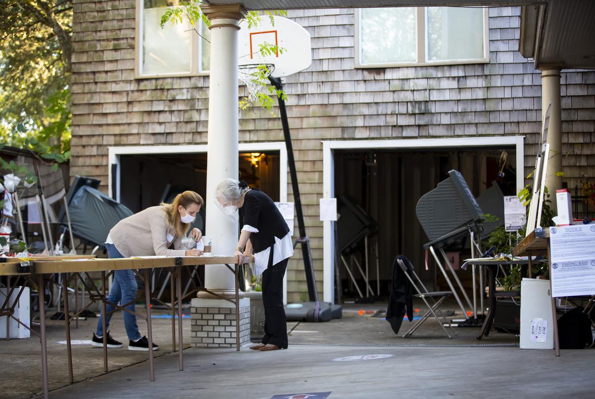 Joanne Brodsky, center, chats in her garage-turned-polling location on Tuesday during Election Day in Houston on Nov. 3, 2020.