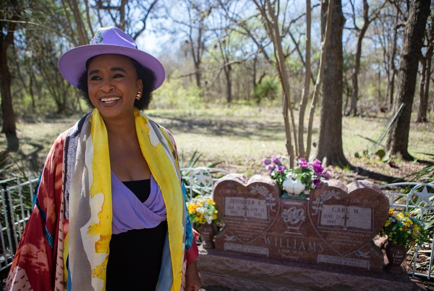 Rosalind Alexander-Kasparik stands by her sister's grave in the Alexander family cemetery on Tuesday, Mar. 22, 2022. Alexander-Kasparik said she feels at home by her sister's grave.