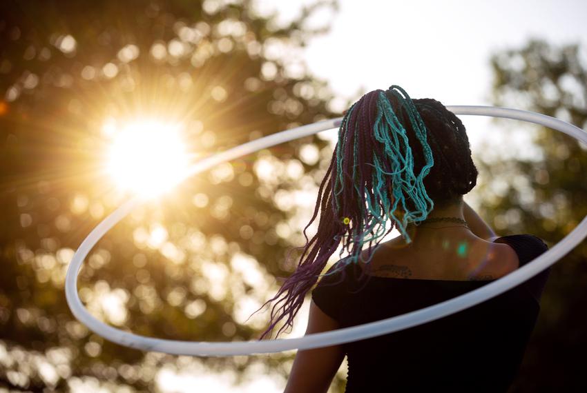 Crystal Sellars hula hoops as the sun sets on the "I Am Juneteenth" festival at the Panther Island Pavilion in Fort Worth on June 19, 2021.