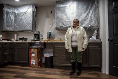Christine Lopez in her kitchen in Friendswood on Tuesday, Dec. 10, 2019. The home was severely damaged by flood water as a result of Hurricane Harvey in 2017.