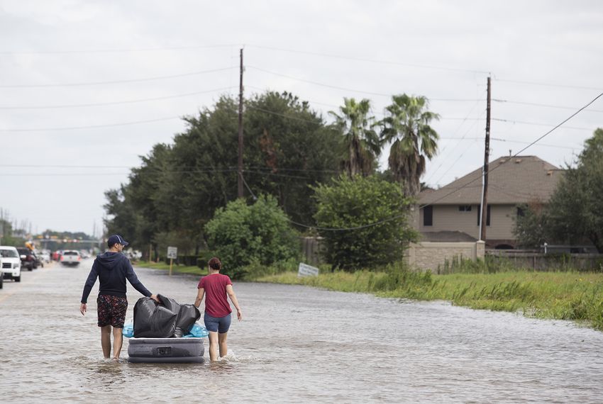 Jeremy Boutor removed personal items on an air mattress from his home after Hurricane Harvey.