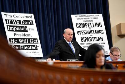U.S. Rep. Louie Gohmert, R-Tyler, stands before a sign with a quote from U.S. Rep. Al Green, D-Houston: “I’m concerned if we don’t impeach this president, he will get re-elected.”