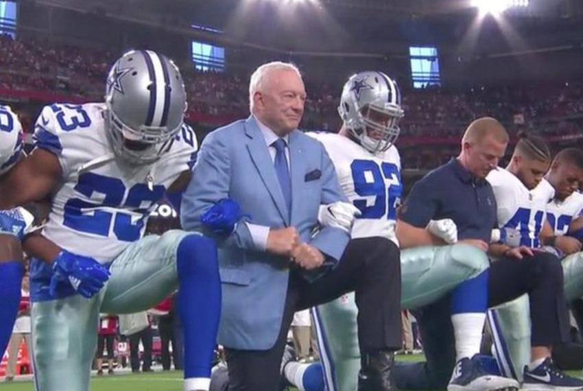 The entire Dallas Cowboys football team takes a knee prior to the national anthem during a game against the Arizona Cardinals on Sept. 25, 2017. 