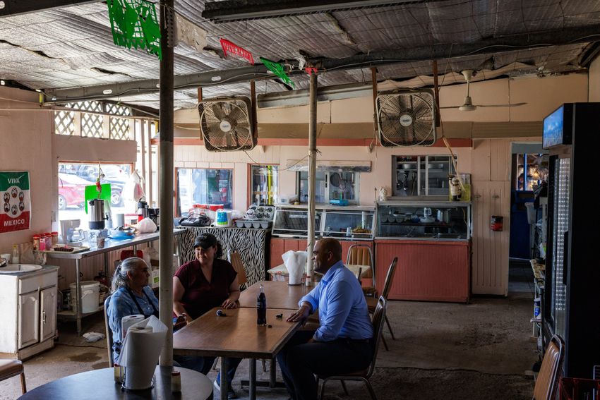 Former U.S. Rep. Colin Allred and former TX-15 Democratic candidate Michelle Vallejo talk to Hilda Lopez, the owner of the restaurant La MalagueÒa at Pulga Los Portales in Alton on Oct. 2, 2025.
