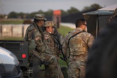 National Guard soldiers stand guard near the U.S. and Mexico border in Del Rio on July 22, 2021.