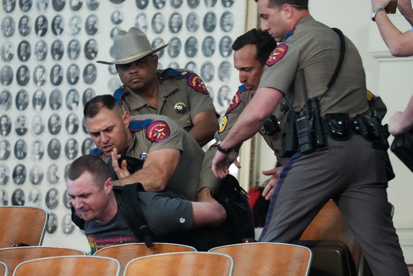 Texas DPS detains a protester in the House gallery after a point of order was raised on SB14 the transgender rights bill on May 2, 2023.