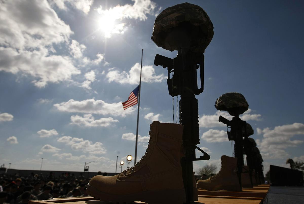 A fallen soldier memorial lines the stage before the start of the III Corps and Fort Hood Memorial Ceremony November 10, 2009 held to honor the 13 victims of the shootings which took place on the Fort Hood Army post in Fort Hood, Texas. REUTERS/Kevin Lamarque (UNITED STATES MILITARY CRIME LAW)
