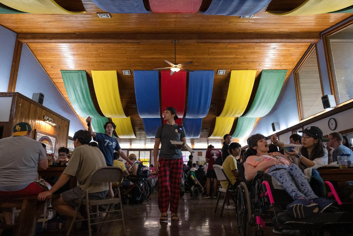 Campers and counselors sit down for breakfast at Camp CAMP, a summer camp hosted by Children’s Association for Maximum Potential for people with disabilities, on Tuesday, July 22, 2025, in Center Point.