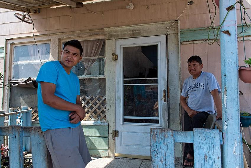 L to R:  Martin Gomez Jr. and his father Martin Gomez Sr. both work, but make so little that they aren't interested in buying healthcare insurance. The Gomez family lives in a colonia near Alton.