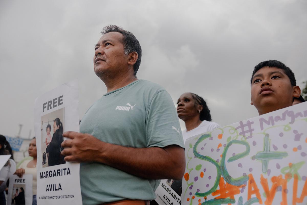 José and his son, Isaac attend a FIEL action in front of the Core Civic Processing Center where Margarita Avila and others are being detained, Friday, June 13, 2025, in Houston. The action focused on the increase in detentions, and let those inside the facility feel that they were not alone. 

(Lexi Parra for The Texas Tribune)