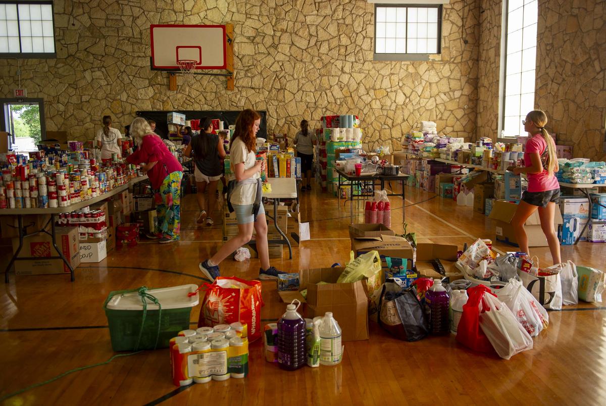 People organize donated supplies for flood relief efforts at the Center Point Independant School District building Tuesday July 8, 2025 in Center Point, Texas.