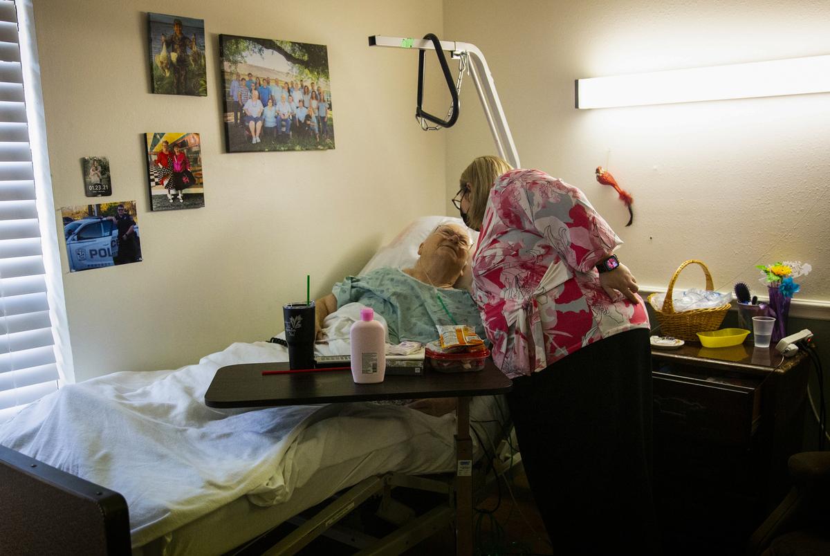 Executive Director of Operations Jeannie Dupree hugs her grandmother, Pauline, at Focused Care at Brenham, a nursing home that experienced an outbreak of COVID-19 positive patients after the winter storm in Texas, on Thursday, April 1, 2021. Dupree is grateful her grandmother lives in the facility she directs so she could have visitors during the pandemic.