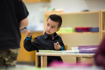 Class ambassador Dilan Almonacio uses hand gestures to communicate at East Texas Montessori Prep Academy.