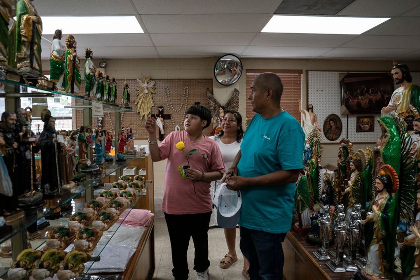 Jaime Galván, 48, his wife and son Oscar look at religious statues at the Saint Jude store in Pharr, Texas on April 23, 2025. 
Gabriel V. Cárdenas for The Texas Tribune