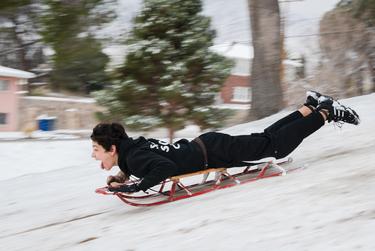 Logan Williams sleds down a hill at Memorial Park in El Paso, Texas on February 15, 2021.