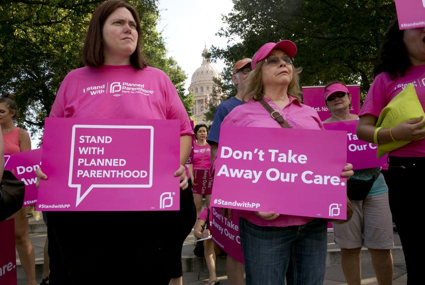 Planned Parenthood supporters rally outside the Texas Capitol on July 29. State health officials announced they want to kick Planned Parenthood out of the state Medicaid program, but the organization is still receiving funds to provide health care for about 13,500 low-income women a year. 