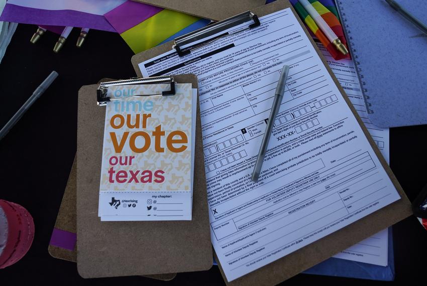 Applications to register were available at a table during a Pride celebration in Corpus Christi on Oct. 5, 2024. In larger counties, deputy registrars help generate a large volume of registrations through community outreach. (Gabriel Cárdenas for Votebeat)