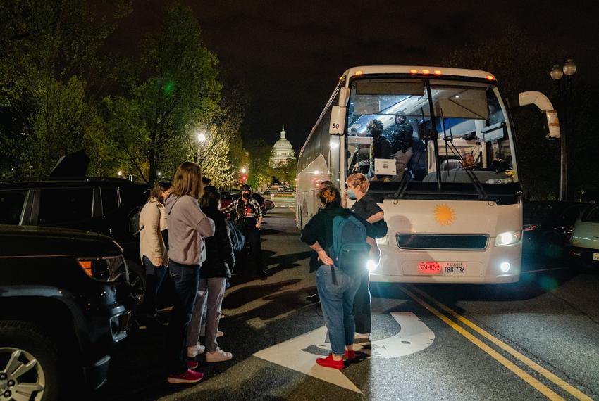 Union Station, Washington, DC - Activists line up for escort as two buses of migrants arrive near Union Station as part of Gov. Greg Abbott’s new plan in response to the end of Title 42, a pandemic-era emergency health order to that allowed immigration authorities at the border to deny entry to migrants in Washington, DC, on Thursday, April 21, 2022.