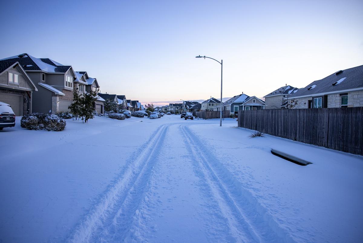The Blanco Vista neighborhood of San Marcos is blanketed with several inches of snow as a massive winter weather system causes power outages across Texas on Feb. 15, 2021.
