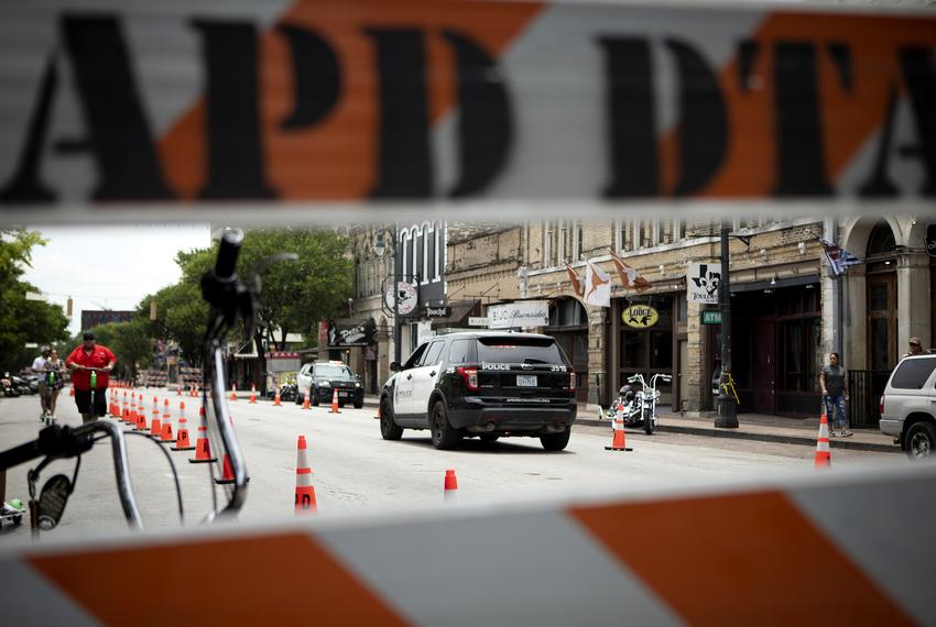 Austin Police patrol the site of a recent mass shooting. At least 13 people were injured in a shooting on East Sixth Street near Trinity Street in Austin in the early hours of Jun 12, 2021.