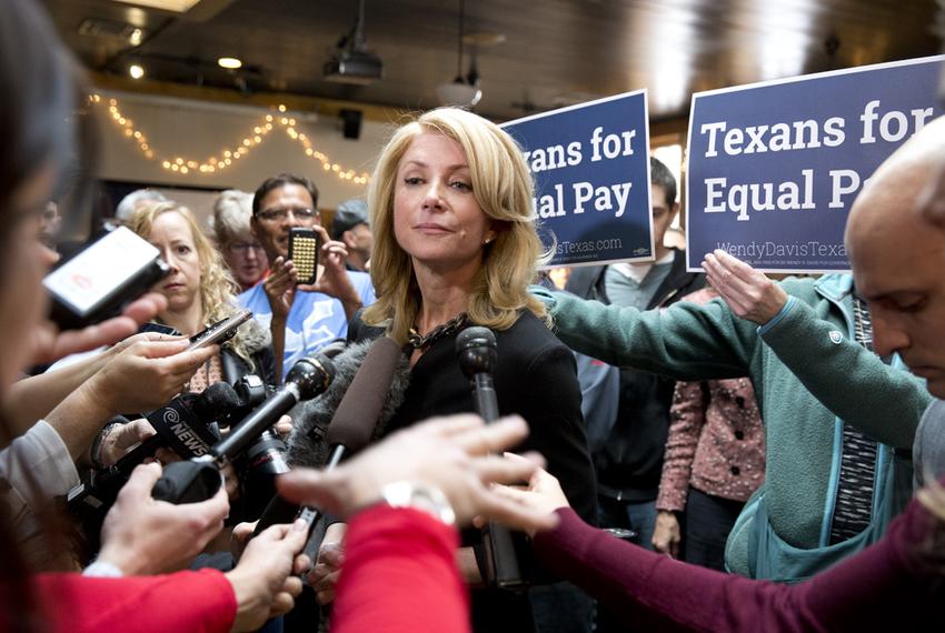 Wendy Davis listens to a press question at Scholtz Garden on March 24, 2014 following an equal pay rally.