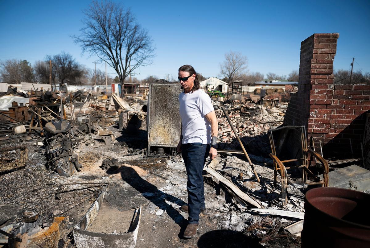 Scott McBroom walks through the rubble of his burned house Friday, March. 1, 2024, in Fritch, Texas.
