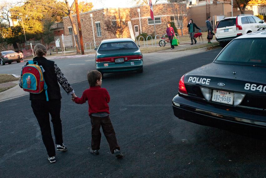 A police officer monitors Maplewood Elementary School in Austin on Monday, Dec. 17, 2012, a few days after the Sandy Hook Elementary School shooting.                                                                                                                                                                                                                               