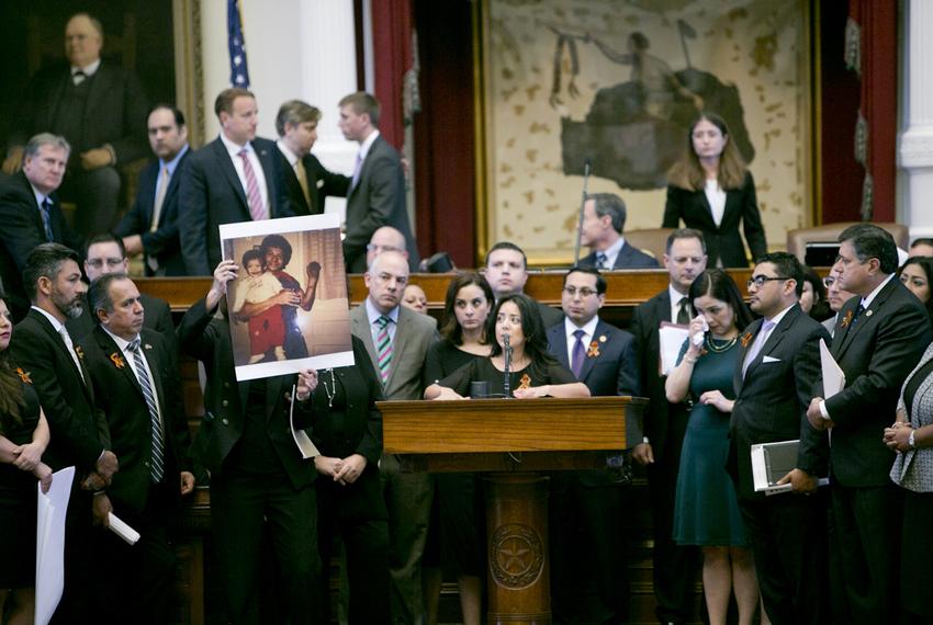 State Rep. Veronica Neave, D-Dallas, gives an emotional speech as a picture of her father is held up during the debate on SB4 — the "sanctuary cities" bill — on April 26, 2017.  