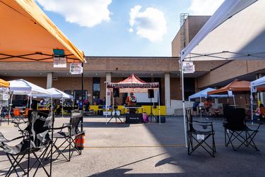 A DJ plays to a small crowd at a tailgate event for the University of Texas football home opener against UTEP on Sept. 12, 2020.