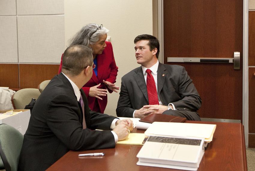 Dan Neil at table with attorneys during a public hearing for the election contest of House D-48