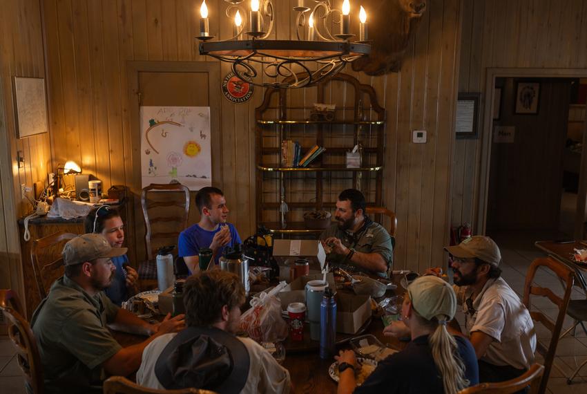 Texas Parks and Wildlife Department biologists, staff, and interns sit down for lunch following an aquatic sampling search for amphibians and fish at Yancey Creek in what will become Post Oak Ridge State Park, a newly acquired park near Lampasas, Texas, on Thursday, June 5, 2025. The park’s acquisition marks the first since $1 billion dollars were allocated to buy more land for the state parks system as part of the Centennial Parks Conservation Fund, approved by the state legislature in 2023. Before development can begin, survey teams collect samples and information regarding the environment and wildlife at the newly acquired land.