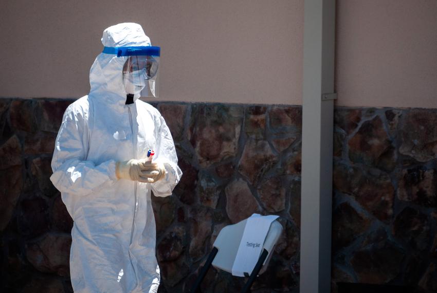 A healthcare worker preps for a COVID-19 test at the drive-thru testing station in Alpine on April 25, 2020.