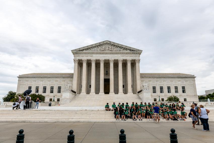 People take photos as a group of children listen to a tour guide at the Supreme Court in Washington, D.C. on Sept. 21, 2021.