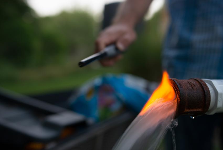 Steve Lipsky shows the methane contamination of his well by igniting the gas with a lighter outside his family's home in Parker County near Weatherford on June 17.