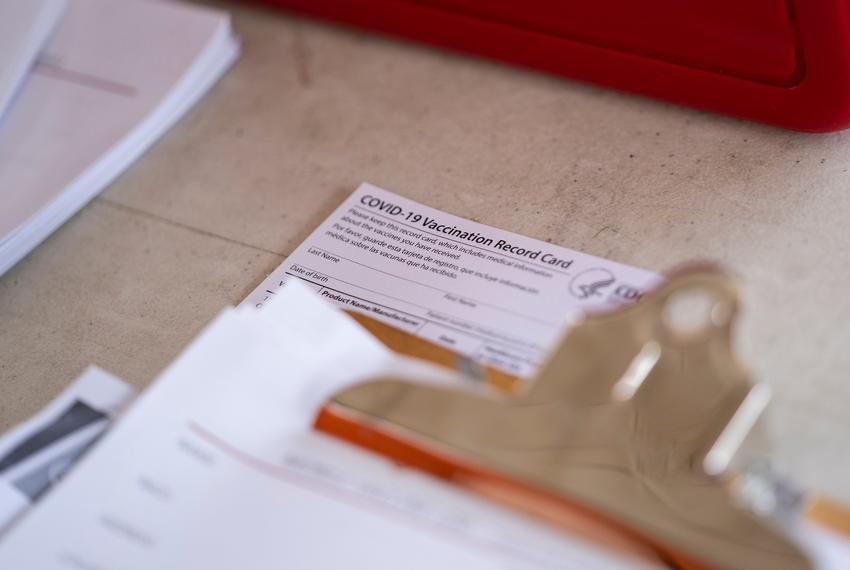 A COVID-19 Vaccination Record Card sits on a table at a vaccine clinic held in partnership between the Central Texas Food Bank and University of Texas in Austin on July 21, 2021.